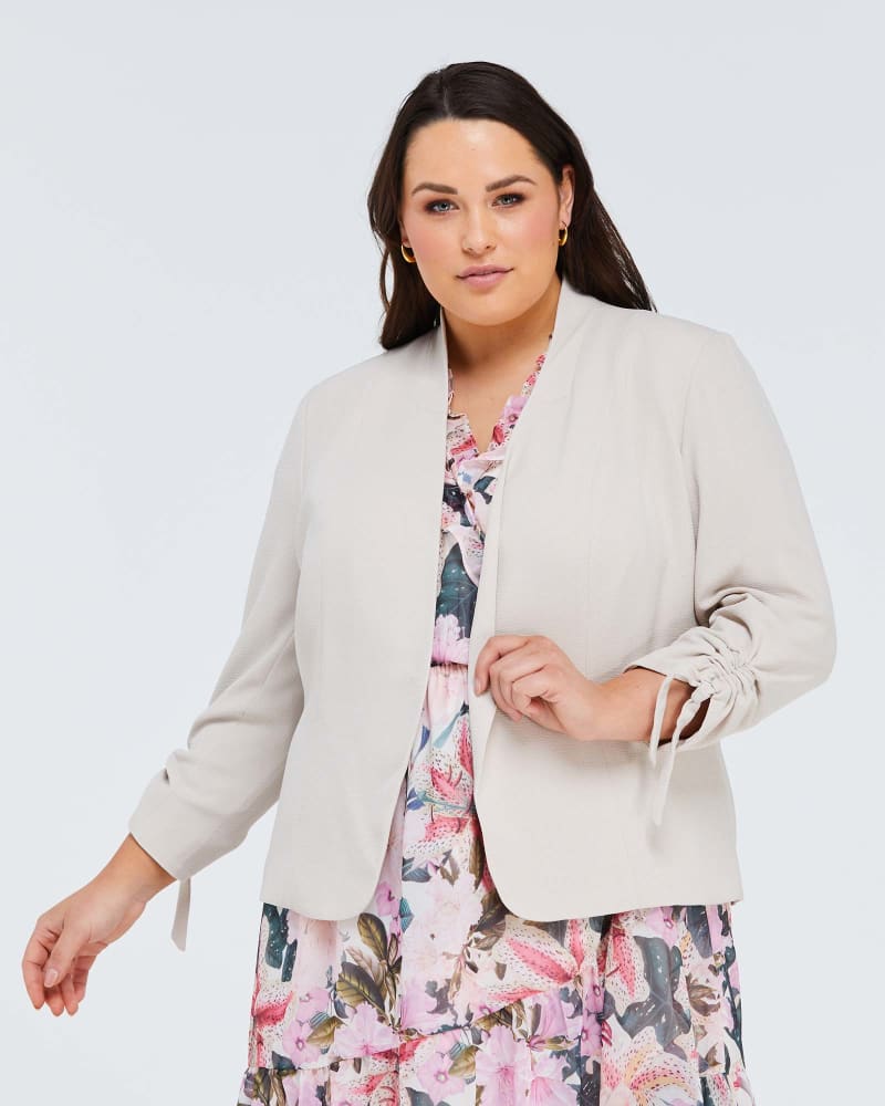 Front of a model wearing a size 4X Thea Bow Sleeve Jacket in Nude by Estelle. | dia_product_style_image_id:264636